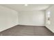 This bedroom has neutral walls and carpet, and a large window at 7152 Jackson Dr, Cumberland, IN 46229