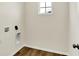 Functional laundry room with modern hookups and natural light from a small window at 7152 Jackson Dr, Cumberland, IN 46229