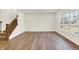 Bright living room featuring hardwood floors, a staircase, and ample natural light at 7152 Jackson Dr, Cumberland, IN 46229