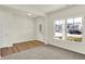 Bright living space with carpet and wood flooring, offering ample natural light through a large window at 7152 Jackson Dr, Cumberland, IN 46229