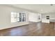 Open-concept living space with hardwood floors seamlessly flowing into a modern kitchen at 7152 Jackson Dr, Cumberland, IN 46229