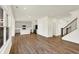 Open-concept living space with hardwood floors seamlessly flowing into a modern kitchen at 7152 Jackson Dr, Cumberland, IN 46229