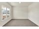 Bright, empty room with large window and neutral carpet, ready for personalization and decor at 7152 Jackson Dr, Cumberland, IN 46229