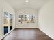Bright sunroom featuring three large windows and sliding glass doors to the outdoors at 7152 Jackson Dr, Cumberland, IN 46229