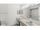A bathroom enhanced by vanity lighting and a mirrored shower tub at 7434 King George Dr # A, Indianapolis, IN 46260
