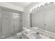 Bright bathroom featuring a shower with sliding glass doors, tile floors, and a large vanity with a marble countertop at 7434 King George Dr # A, Indianapolis, IN 46260