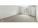 A bedroom bathed in natural light, enhanced by plush carpeting and serene, white walls at 7434 King George Dr # A, Indianapolis, IN 46260