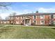 Brick two story building with well-maintained lawn at 7434 King George Dr # A, Indianapolis, IN 46260