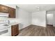 A well-lit kitchen space, with wood cabinets, white countertops, and a view from the window at 7434 King George Dr # A, Indianapolis, IN 46260