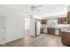 Open kitchen with wood cabinets, laminate countertops and hardwood flooring at 7434 King George Dr # A, Indianapolis, IN 46260