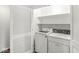 Bright laundry room with shelving and modern washer and dryer units at 7434 King George Dr # A, Indianapolis, IN 46260
