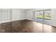 Living room featuring built-in shelves and sliding glass door at 7434 King George Dr # A, Indianapolis, IN 46260