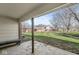 Covered patio providing a shady retreat with views of the lush green lawn and community buildings at 7434 King George Dr # A, Indianapolis, IN 46260