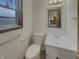 Cozy bathroom with a classic toilet, vanity, and a mirror, offering a functional and tidy space at 8507 Palm Ct, Indianapolis, IN 46219