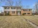 Two-story home featuring a brick and siding exterior, a small balcony, and a well-maintained front yard at 8507 Palm Ct, Indianapolis, IN 46219