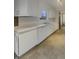 Bright kitchen with white cabinets, matching appliances, and ample counter space for meal preparation at 8507 Palm Ct, Indianapolis, IN 46219