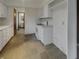 Bright kitchen with white cabinets and a view into an adjacent bathroom, creating a cohesive living space at 8507 Palm Ct, Indianapolis, IN 46219