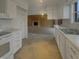 Open kitchen with white cabinets and a view into the living room, great for entertaining and Gathering time at 8507 Palm Ct, Indianapolis, IN 46219