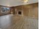 Living room featuring wood paneling, a brick fireplace, and wood-look flooring at 8507 Palm Ct, Indianapolis, IN 46219