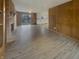 Spacious living room with a brick fireplace and wood paneling, offering a cozy and classic feel at 8507 Palm Ct, Indianapolis, IN 46219