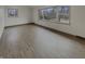 Bright living room with light hardwood floors and multiple windows, creating an inviting and airy atmosphere at 8507 Palm Ct, Indianapolis, IN 46219
