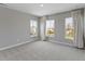 Bright bedroom featuring plush carpet, neutral paint, and three windows for natural light at 903 E 16Th St, Indianapolis, IN 46202