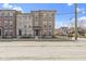 Charming brick townhome featuring multiple stories, a fenced yard and professionally landscaped grounds at 903 E 16Th St, Indianapolis, IN 46202