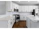 Gourmet kitchen features white cabinets, stainless steel appliances, tile backsplash, and wood flooring at 903 E 16Th St, Indianapolis, IN 46202