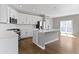 Modern kitchen featuring white cabinets, stainless steel appliances, and access to the outdoor balcony at 903 E 16Th St, Indianapolis, IN 46202