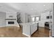 Open-concept kitchen with island, stainless appliances, a fireplace, and hardwood flooring throughout at 903 E 16Th St, Indianapolis, IN 46202