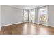 Bright living area with hardwood floors and three large windows at 903 E 16Th St, Indianapolis, IN 46202