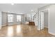 Open-concept living area showcasing hardwood floors, a staircase, and plenty of natural light at 903 E 16Th St, Indianapolis, IN 46202