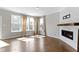 Sunlit living room with hardwood floors and a cozy fireplace at 903 E 16Th St, Indianapolis, IN 46202