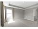 Spacious main bedroom featuring a tray ceiling and a large window at 903 E 16Th St, Indianapolis, IN 46202