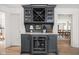 Elegant bar area with custom cabinetry and a built-in wine fridge at 9080 Pickwick Dr, Indianapolis, IN 46260