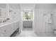 Bright bathroom featuring a vanity with drawers, storage tower, and a large window offering natural light at 9080 Pickwick Dr, Indianapolis, IN 46260