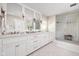 Bright bathroom with double vanity, large mirrors, and a glass-enclosed shower at 9080 Pickwick Dr, Indianapolis, IN 46260