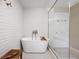 Elegant bathroom showcasing a modern soaking tub and a glass-enclosed shower with white tile at 9080 Pickwick Dr, Indianapolis, IN 46260