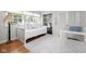 Bright bedroom with daybed, built-in shelves, and a closet, complemented by a hardwood floor and area rug at 9080 Pickwick Dr, Indianapolis, IN 46260