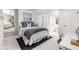 Bright bedroom featuring a bed with blue accents, a desk, and ample natural light from a window at 9080 Pickwick Dr, Indianapolis, IN 46260