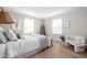Bright bedroom featuring hardwood floors, neutral walls, and a comfortable bed with stylish linens at 9080 Pickwick Dr, Indianapolis, IN 46260