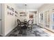Charming dining room with a round table, slate floors, and access to outdoor patio at 9080 Pickwick Dr, Indianapolis, IN 46260
