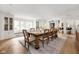 Elegant dining room with large windows, built-in cabinets, and a spacious table setting at 9080 Pickwick Dr, Indianapolis, IN 46260