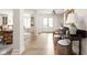 Open foyer featuring hardwood floors, console table with decor, and view to dining area at 9080 Pickwick Dr, Indianapolis, IN 46260