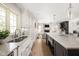 Bright kitchen with subway tile backsplash, stainless steel sink, and view to a cozy living space at 9080 Pickwick Dr, Indianapolis, IN 46260