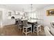 Spacious kitchen featuring a large island, white cabinets, and stainless-steel appliances at 9080 Pickwick Dr, Indianapolis, IN 46260