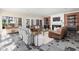 Spacious living room with a brick fireplace, leather seating, slate floors, and plenty of natural light at 9080 Pickwick Dr, Indianapolis, IN 46260