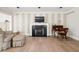 Inviting living room featuring a cozy fireplace and a workspace with stylish desk and chair at 9080 Pickwick Dr, Indianapolis, IN 46260