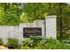 A white brick entrance sign for 'Pickwick Drive' neighborhood, emphasizing a patrolled and secure area at 9080 Pickwick Dr, Indianapolis, IN 46260