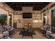 Outdoor entertainment space with fireplace, bar, TV, comfortable seating, and outdoor dining at 9080 Pickwick Dr, Indianapolis, IN 46260